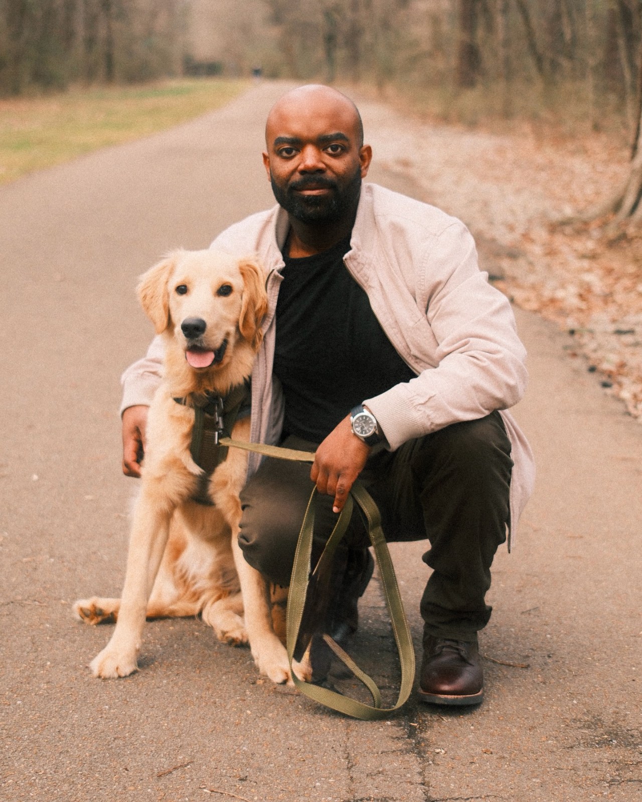 Tyrian Horton with a golden retriever, late-winter light.